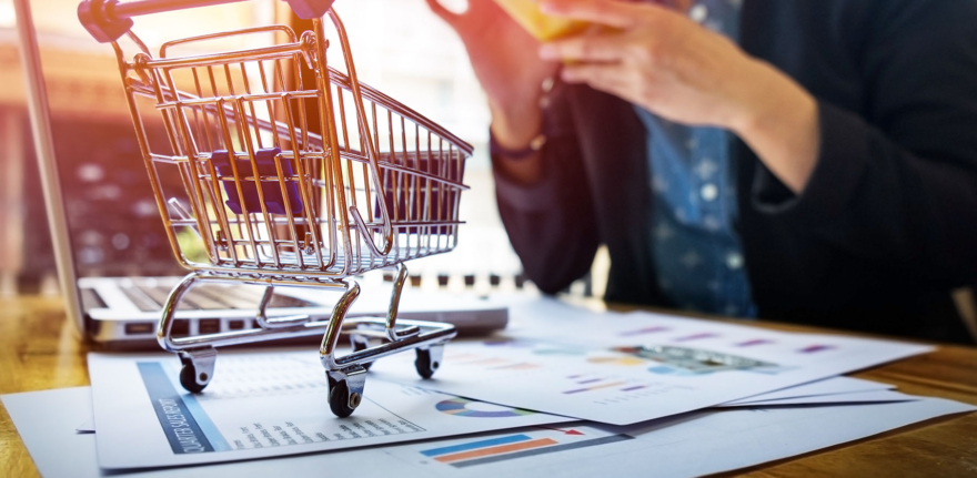 Cropped image of woman inputting card information and key on phone or laptop while shopping online.